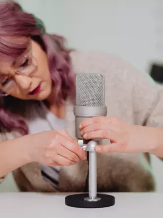 Lady setting up microphone for audio